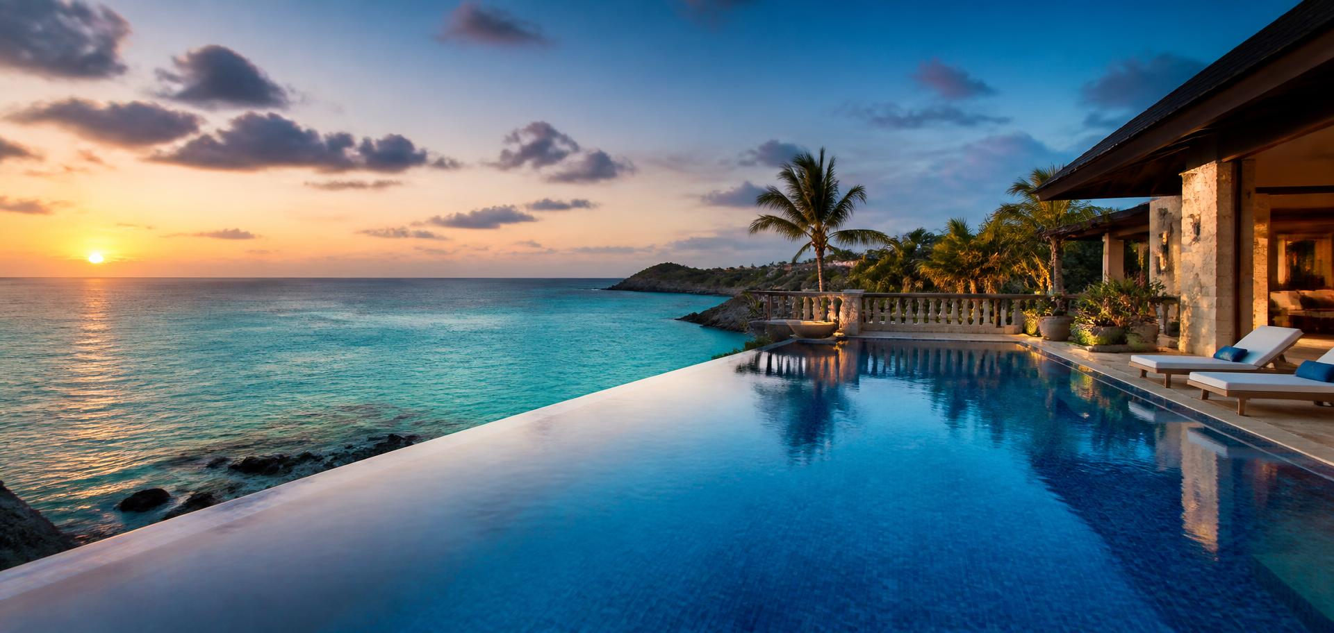 Infinity pool overlooking the ocean at sunset